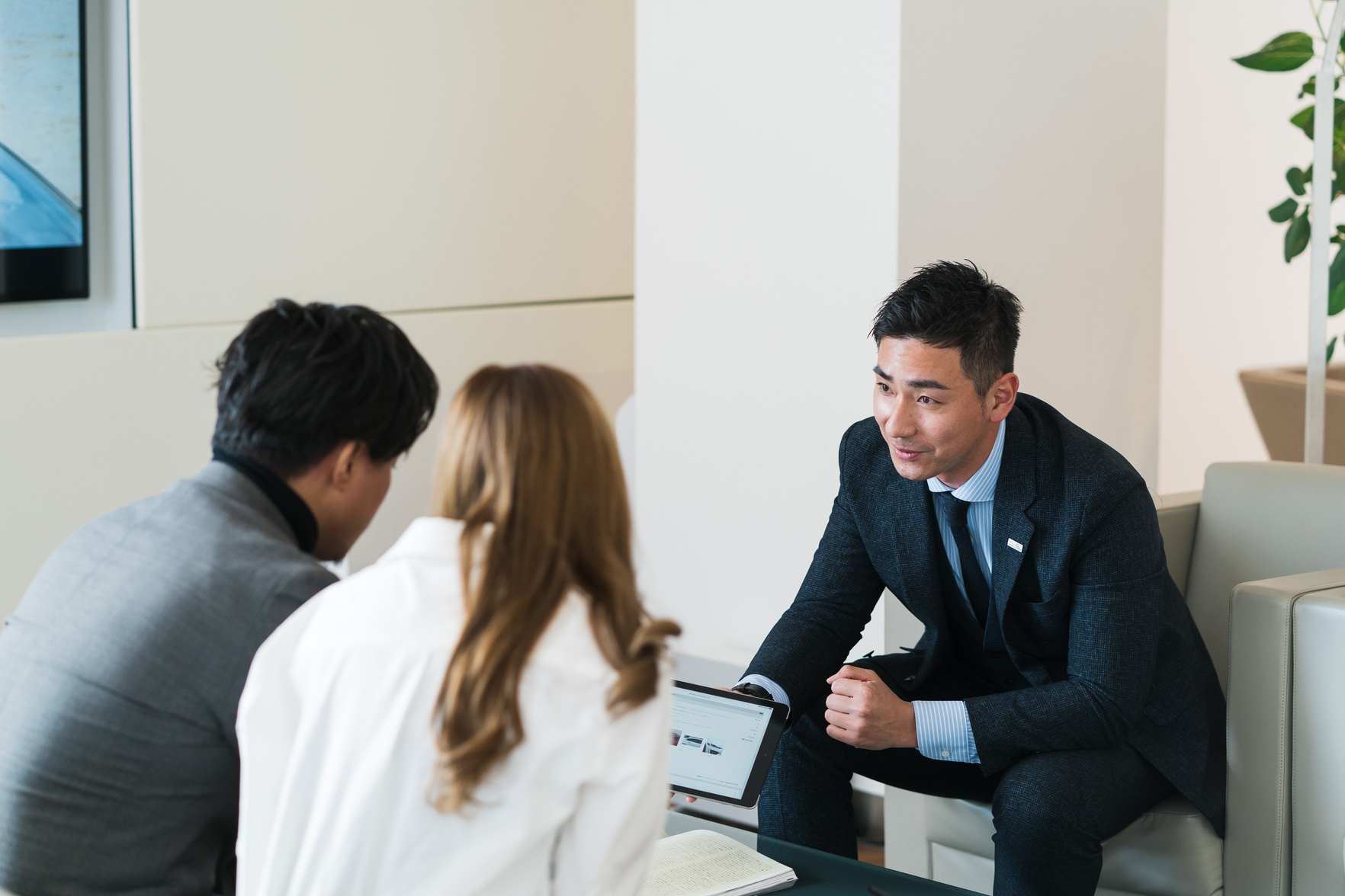 Couple Chatting with a Car Salesperson