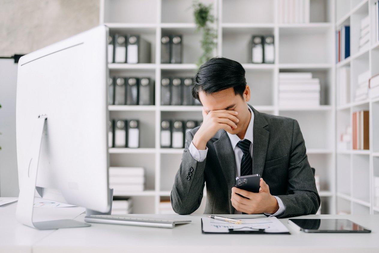 Asian business man is stressed, bored, and overthinking from wor