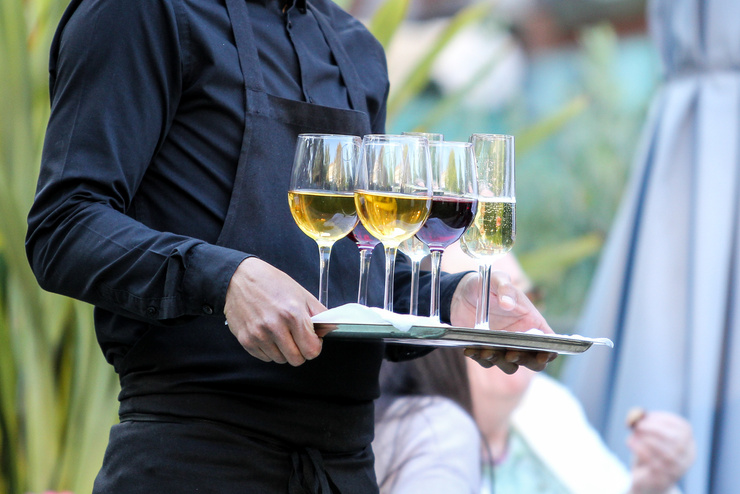 A Waiter serves glasses of Wine