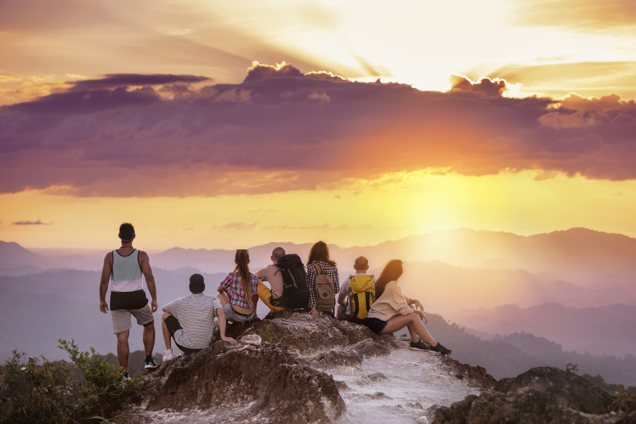 Big group friends mountain top sunset