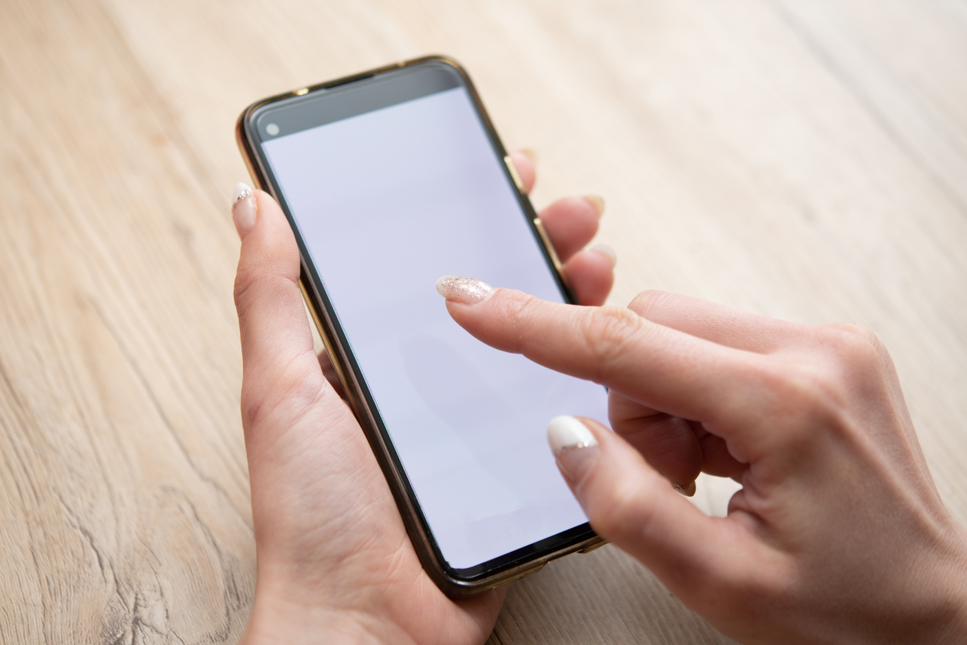Female hand operating a smartphone